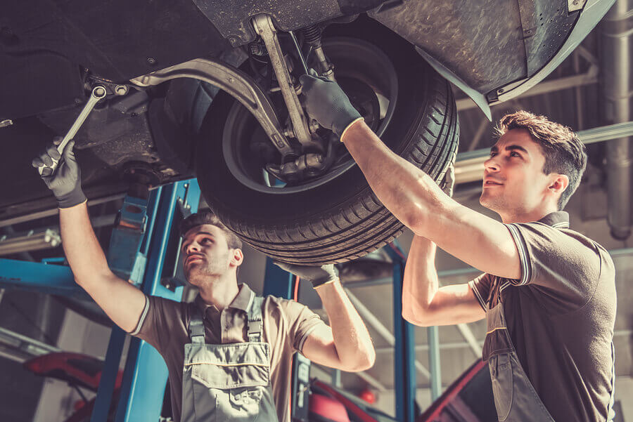 2 Mechanics working on a raised car